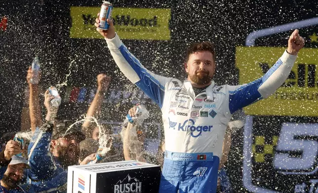 Driver Ricky Stenhouse Jr. celebrates in Victory Lane after a NASCAR Cup Series auto race at Talladega Superspeedway, Sunday, Oct. 6, 2024, in Talladega, Ala. (AP Photo/ Butch Dill)