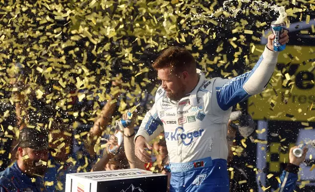 Driver Ricky Stenhouse Jr. celebrates in Victory Lane after a NASCAR Cup Series auto race at Talladega Superspeedway, Sunday, Oct. 6, 2024, in Talladega, Ala. (AP Photo/ Butch Dill)