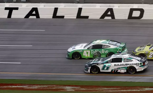 Driver Ricky Stenhouse Jr. (47) leads the way to the finish line during a NASCAR Cup Series auto race at Talladega Superspeedway, Sunday, Oct. 6, 2024, in Talladega, Ala. (AP Photo/ Butch Dill)