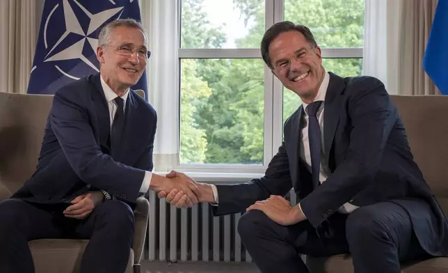 FILE - NATO Secretary General Jens Stoltenberg, left, and then-Dutch Prime Minister Mark Rutte shake hands for the cameras prior to a meeting in The Hague, Netherlands, Tuesday, June 27, 2023. (AP Photo/Peter Dejong, File)