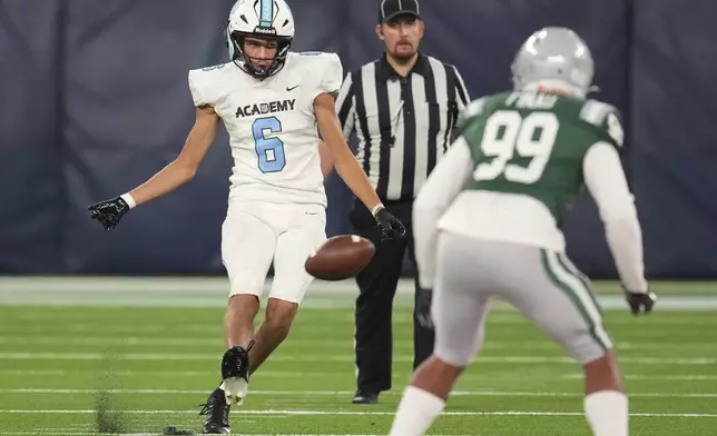 NFL Academy player Rafael Varona Blackstad, left, kicks a ball during a football game between the NFL Academy team and De La Salle High School, Tuesday, Oct. 8, 2024, in London. (AP Photo/Kin Cheung)