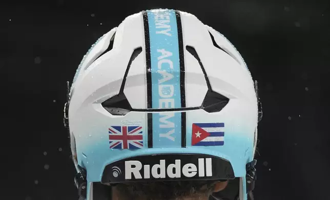 NFL Academy player Rafael Varona Blackstad, wears a helmet during a football game between the NFL Academy team and De La Salle High School, Tuesday, Oct. 8, 2024, in London. (AP Photo/Kin Cheung)