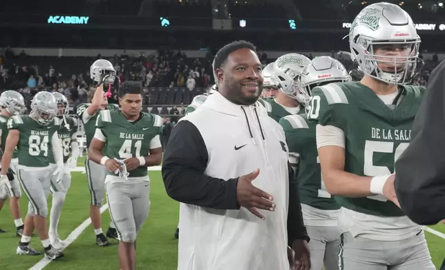 De La Salle High School coach and former NFL running back Maurice Jones-Drew shakes hands after a football game between the NFL Academy team and De La Salle High School in London, Tuesday, Oct. 8, 2024. (AP Photo/Kin Cheung)