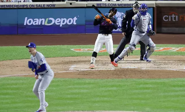 Los Angeles Dodgers pitcher Walker Buehler and catcher Will Smith celebrate after New York Mets' Francisco Lindor strike out with the bases loaded to end the second inning in Game 3 of a baseball NL Championship Series, Wednesday, Oct. 16, 2024, in New York. (AP Photo/Adam Hunger)