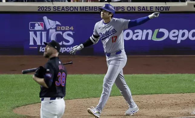 Los Angeles Dodgers' Shohei Ohtani celebrates his three-run home run against the New York Mets during the eighth inning in Game 3 of a baseball NL Championship Series, Wednesday, Oct. 16, 2024, in New York. (AP Photo/Adam Hunger)