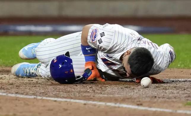 New York Mets' Francisco Alvarez gets hit by pitch against the Los Angeles Dodgers during the fifth inning in Game 4 of a baseball NL Championship Series, Thursday, Oct. 17, 2024, in New York. (AP Photo/Ashley Landis)