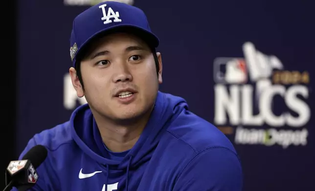 Los Angeles Dodgers' Shohei Ohtani talks to the media Tuesday, Oct. 15, 2024, in New York ahead of Game 3 of the baseball NL Championship Series against the New York Mets. (AP Photo/Adam Hunger)