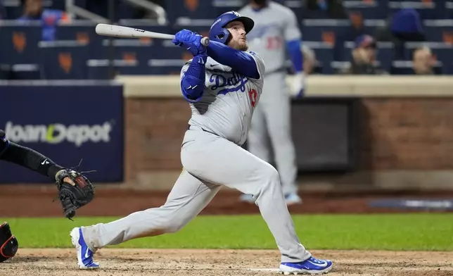 Los Angeles Dodgers' Max Muncy watches his home run against the New York Mets during the ninth inning in Game 3 of a baseball NL Championship Series, Wednesday, Oct. 16, 2024, in New York. (AP Photo/Ashley Landis)