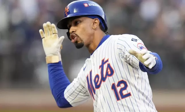 New York Mets' Francisco Lindor celebrates a single against the Los Angeles Dodgers during the first inning in Game 5 of a baseball NL Championship Series, Friday, Oct. 18, 2024, in New York. (AP Photo/Frank Franklin II)