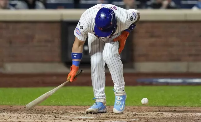 New York Mets' Francisco Alvarez gets hit by pitch against the Los Angeles Dodgers during the fifth inning in Game 4 of a baseball NL Championship Series, Thursday, Oct. 17, 2024, in New York. (AP Photo/Ashley Landis)