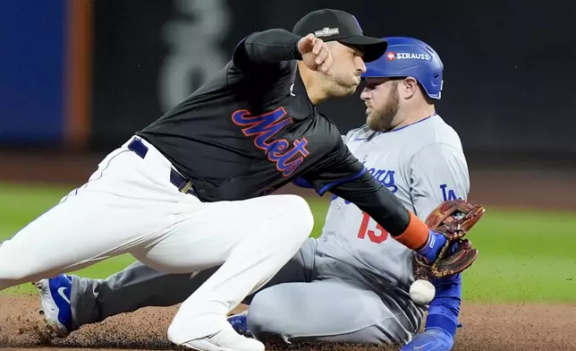 Los Angeles Dodgers' Max Muncy is safe past New York Mets second baseman Jose Iglesias during the second inning in Game 3 of a baseball NL Championship Series, Wednesday, Oct. 16, 2024, in New York. (AP Photo/Frank Franklin II)