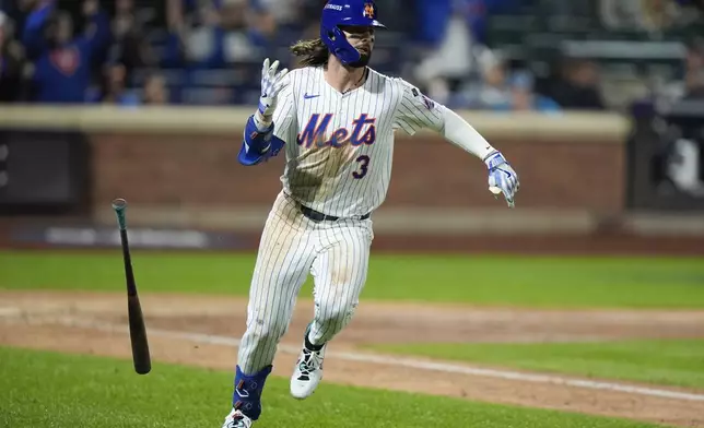 New York Mets' Jesse Winker watches his single against the Los Angeles Dodgers during the eighth inning in Game 5 of a baseball NL Championship Series, Friday, Oct. 18, 2024, in New York. (AP Photo/Frank Franklin II)