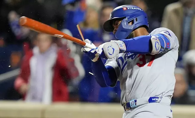 Los Angeles Dodgers' Teoscar Hernández breaks is bat and flys out against the New York Mets during the third inning in Game 3 of a baseball NL Championship Series, Wednesday, Oct. 16, 2024, in New York. (AP Photo/Frank Franklin II)