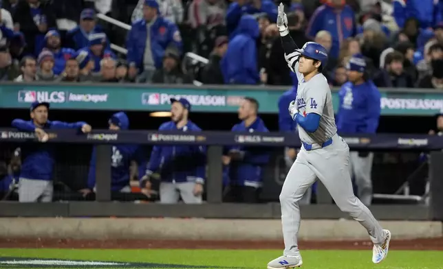 Los Angeles Dodgers' Shohei Ohtani celebrates his three-run home run against the New York Mets during the eighth inning in Game 3 of a baseball NL Championship Series, Wednesday, Oct. 16, 2024, in New York. (AP Photo/Ashley Landis)