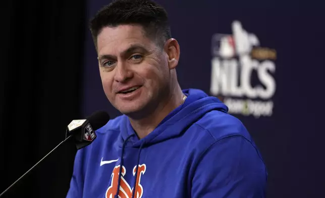 New York Mets manager Carlos Mendoza talks to the media Tuesday, Oct. 15, 2024, in New York ahead of Game 3 of the baseball NL Championship Series against the Los Angeles Dodgers. (AP Photo/Adam Hunger)