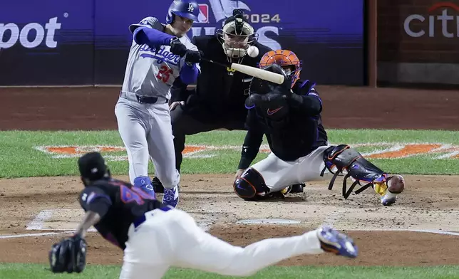 Los Angeles Dodgers' Tommy Edman hits a sacrifice fly during the second inning in Game 3 of a baseball NL Championship Series against the New York Mets, Wednesday, Oct. 16, 2024, in New York. (AP Photo/Adam Hunger)