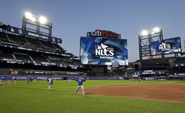 Los Angeles Dodgers players throw during a workout Tuesday, Oct. 15, 2024, in New York ahead of Game 3 of the baseball NL Championship Series against the New York Mets. (AP Photo/Adam Hunger)