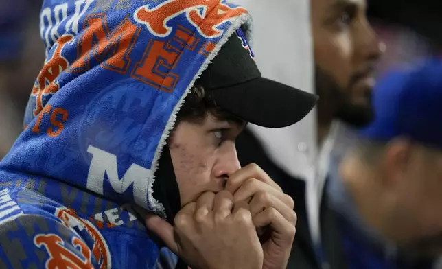 A New York Mets fan watches during their loss against the Los Angeles Dodgers in Game 4 of a baseball NL Championship Series, Thursday, Oct. 17, 2024, in New York. (AP Photo/Ashley Landis)