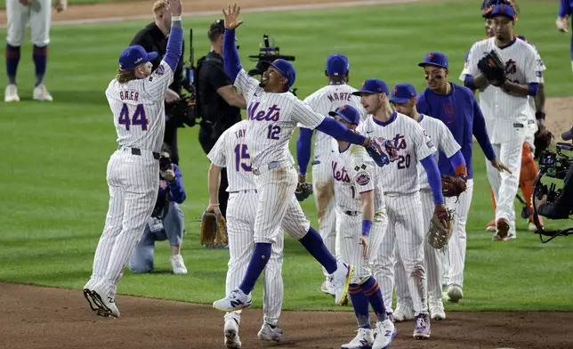 The New York Mets celebrates their win against the Los Angeles Dodgers in Game 5 of a baseball NL Championship Series, Friday, Oct. 18, 2024, in New York. (AP Photo/Adam Hunger)