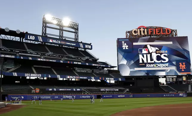 Los Angeles Dodgers players throw during a workout Tuesday, Oct. 15, 2024, in New York ahead of Game 3 of the baseball NL Championship Series against the New York Mets. (AP Photo/Adam Hunger)