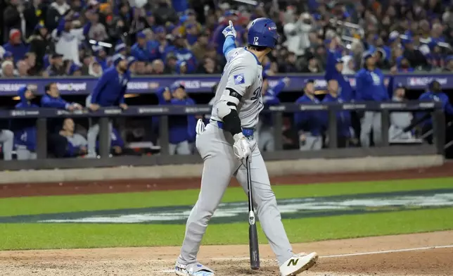 Los Angeles Dodgers' Shohei Ohtani celebrates his three-run home run against the New York Mets during the eighth inning in Game 3 of a baseball NL Championship Series, Wednesday, Oct. 16, 2024, in New York. (AP Photo/Ashley Landis)