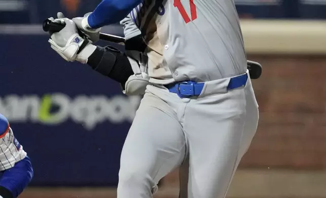 Los Angeles Dodgers' Shohei Ohtani reacts after getting hit with a foul ball during the eighth inning in Game 4 of a baseball NL Championship Series against the New York Mets, Thursday, Oct. 17, 2024, in New York. (AP Photo/Ashley Landis)