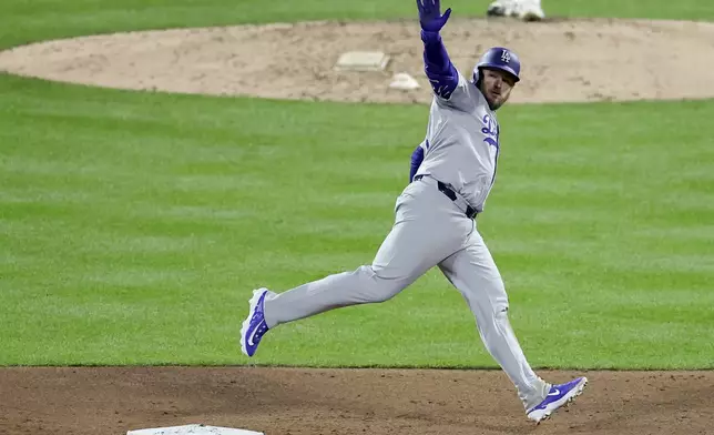 Los Angeles Dodgers' Max Muncy celebrates his home run against the New York Mets during the ninth inning in Game 3 of a baseball NL Championship Series, Wednesday, Oct. 16, 2024, in New York. (AP Photo/Adam Hunger)