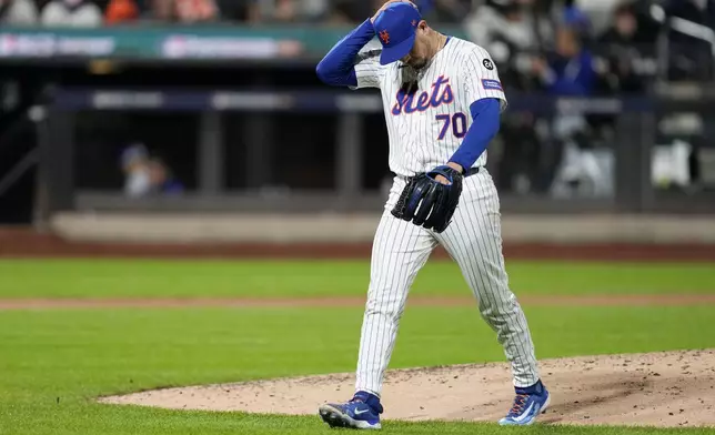 New York Mets pitcher José Buttó leaves the game against the Los Angeles Dodgers during the sixth inning in Game 4 of a baseball NL Championship Series, Thursday, Oct. 17, 2024, in New York. (AP Photo/Ashley Landis)