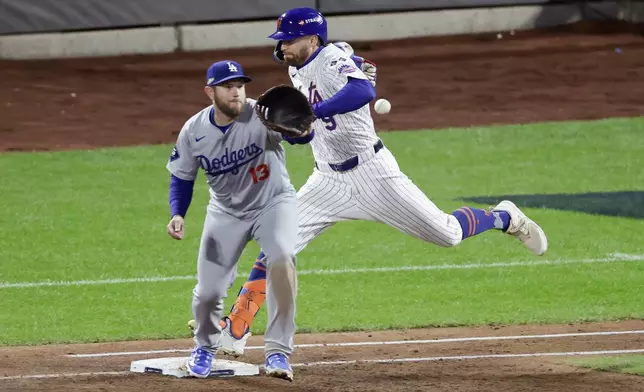 New York Mets' Brandon Nimmo is safe at first past Los Angeles Dodgers first baseman Max Muncy during the third inning in Game 4 of a baseball NL Championship Series, Thursday, Oct. 17, 2024, in New York. (AP Photo/Adam Hunger)