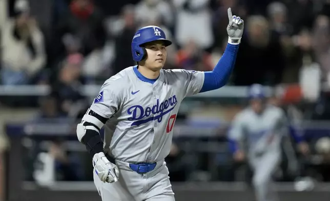 Los Angeles Dodgers' Shohei Ohtani celebrates his three-run home run against the New York Mets during the eighth inning in Game 3 of a baseball NL Championship Series, Wednesday, Oct. 16, 2024, in New York. (AP Photo/Ashley Landis)