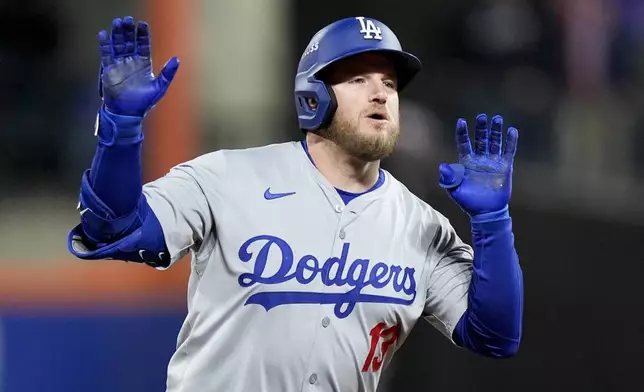 Los Angeles Dodgers' Max Muncy celebrates a home run against the New York Mets during the ninth inning in Game 3 of a baseball NL Championship Series, Wednesday, Oct. 16, 2024, in New York. (AP Photo/Frank Franklin II)