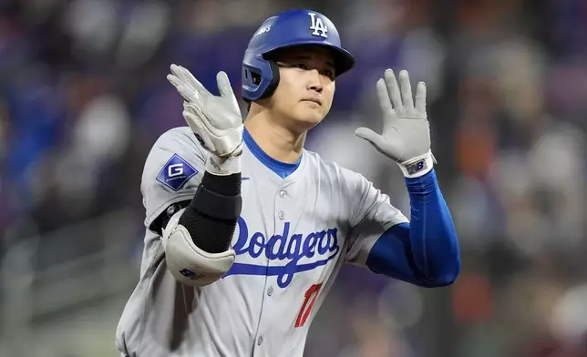 Los Angeles Dodgers' Shohei Ohtani celebrates his three-run home run against the New York Mets during the eighth inning in Game 3 of a baseball NL Championship Series, Wednesday, Oct. 16, 2024, in New York. (AP Photo/Frank Franklin II)