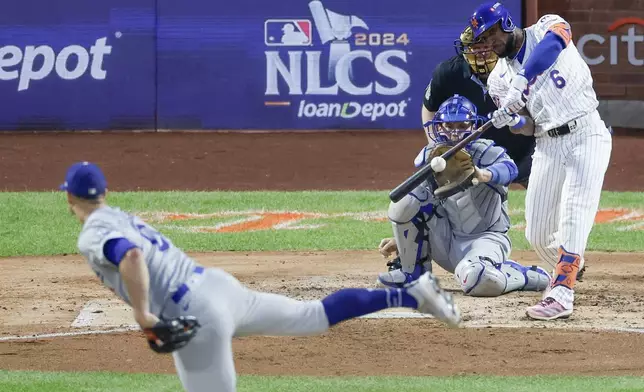 New York Mets' Starling Marte hits a two-run double against the Los Angeles Dodgers during the third inning in Game 5 of a baseball NL Championship Series, Friday, Oct. 18, 2024, in New York. (AP Photo/Adam Hunger)