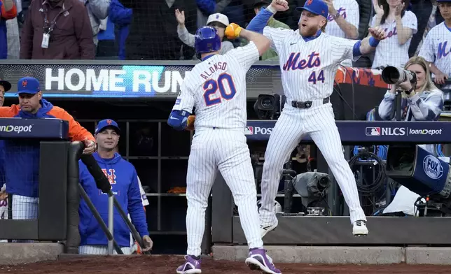 New York Mets' Pete Alonso celebrates a three-run home run against the Los Angeles Dodgers during the first inning in Game 5 of a baseball NL Championship Series, Friday, Oct. 18, 2024, in New York. (AP Photo/Ashley Landis)