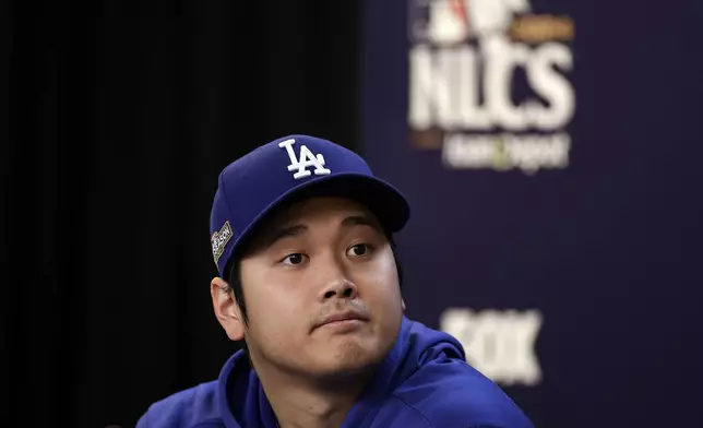 Los Angeles Dodgers' Shohei Ohtani talks to the media Tuesday, Oct. 15, 2024, in New York ahead of Game 3 of the baseball NL Championship Series against the New York Mets. (AP Photo/Adam Hunger)