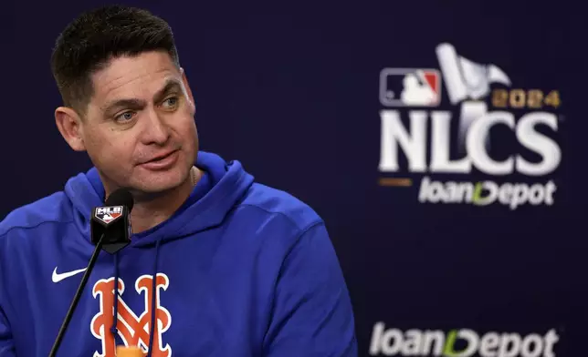 New York Mets manager Carlos Mendoza talks to the media, Tuesday, Oct. 15, 2024, in New York ahead of Game 3 of the baseball NL Championship Series against the Los Angeles Dodgers. (AP Photo/Adam Hunger)