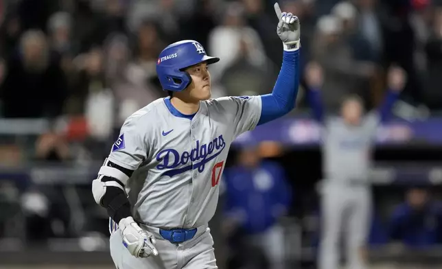 Los Angeles Dodgers' Shohei Ohtani celebrates his three-run home run against the New York Mets during the eighth inning in Game 3 of a baseball NL Championship Series, Wednesday, Oct. 16, 2024, in New York. (AP Photo/Ashley Landis)