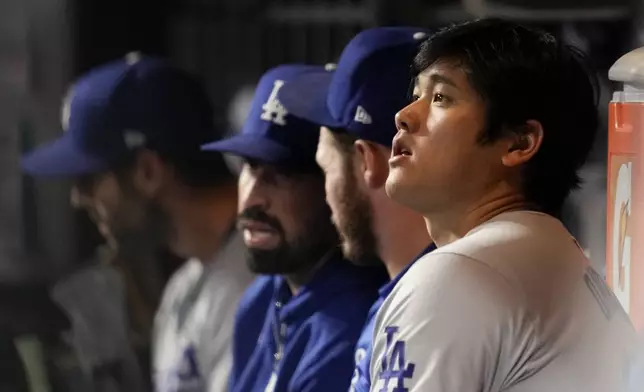 Los Angeles Dodgers' Shohei Ohtani watches during the eighth inning in Game 5 of a baseball NL Championship Series against the New York Mets, Friday, Oct. 18, 2024, in New York. (AP Photo/Ashley Landis)