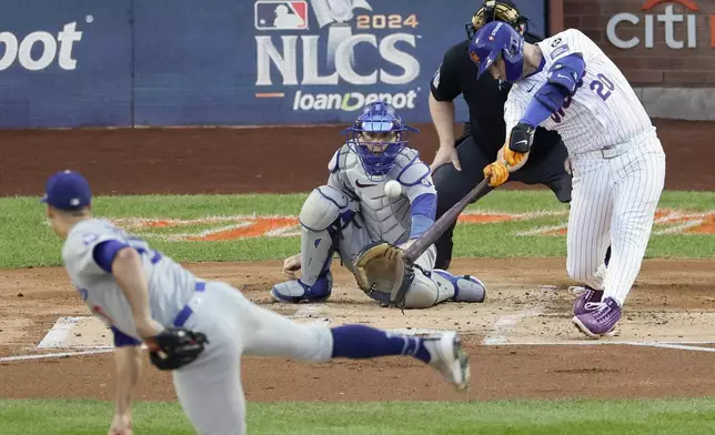 New York Mets' Pete Alonso hits a three-run home run against the Los Angeles Dodgers during the first inning in Game 5 of a baseball NL Championship Series, Friday, Oct. 18, 2024, in New York. (AP Photo/Adam Hunger)