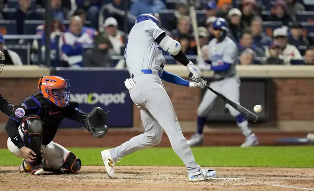 Los Angeles Dodgers' Shohei Ohtani hits a three-run home run against the New York Mets during the eighth inning in Game 3 of a baseball NL Championship Series, Wednesday, Oct. 16, 2024, in New York. (AP Photo/Ashley Landis)