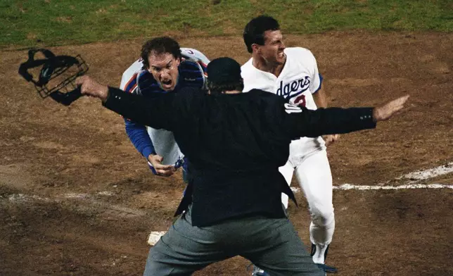 FILE - New York Mets catcher Gary Carter, left, appeals to home plate umpire John McSherry as McSherry calls Los Angeles Dodger Steve Sax (3) safe during the second inning of Game 2 of the National League Championship Series in Los Angeles, Oct. 5, 1988. (AP Photo/Lennox McLendon, File)