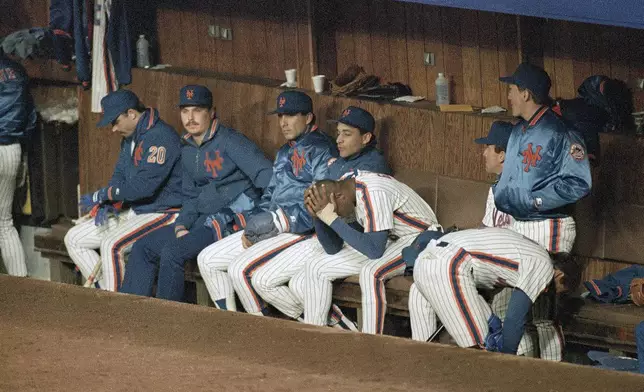 FILE - New York Mets pitcher Dwight Gooden, center, sits with his head in his hands after giving up a two-run homer to Los Angeles Dodgers batter Mike Scioscia to tie the game in the ninth inning of Game 4 of the National League Championship Series in New York, Oct. 9, 1988. Others are unidentified. (AP Photo/Bill Kostroun, File)