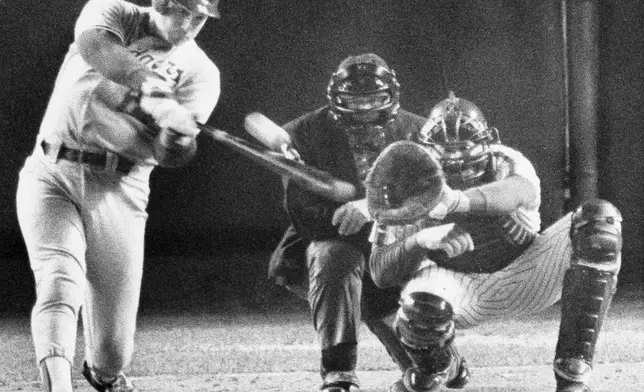 FILE - Los Angeles Dodgers batter Mike Scioscia hits a two-run homer as New York Mets catcher Gary Carter and umpire Dutch Rennert look on, during Game 4 of the National League Championship Series in New York, Oct. 9, 1988. (AP Photo/Richard Drew, File)