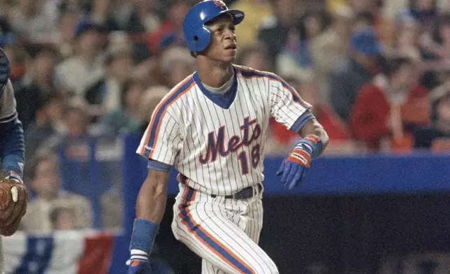 Darryl Strawberry of the New York Mets watches his home run off Los Angeles Dodgers pitcher John Tudor go out in the fourth inning of Game 4 of the National League Championship Series in New York, Oct. 9, 1988. (AP Photo/Mark Lennihan, File)