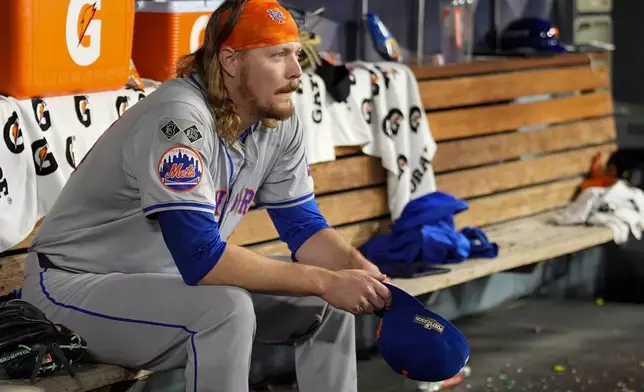 New York Mets pitcher Ryne Stanek sits in the dugout after leaving to games against the Los Angeles Dodgers during the sixth inning in Game 6 of a baseball NL Championship Series, Sunday, Oct. 20, 2024, in Los Angeles. (AP Photo/Julio Cortez)