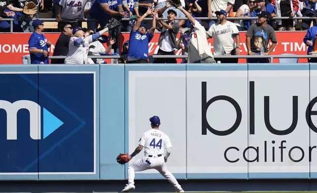 Los Angeles Dodgers centerfielder Andy Pages (44) watches as a ball goes over the wall for a grand slam home run by New York Mets' Mark Vientos during the second inning in Game 2 of a baseball NL Championship Series, Monday, Oct. 14, 2024, in Los Angeles. (AP Photo/Gregory Bull)