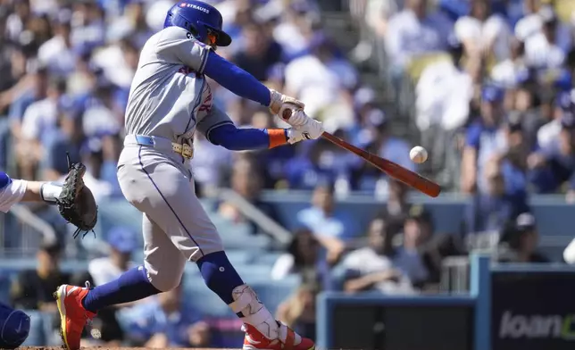 New York Mets' Francisco Lindor connects for a solo home run against the Los Angeles Dodgers during the first inning in Game 2 of a baseball NL Championship Series, Monday, Oct. 14, 2024, in Los Angeles. (AP Photo/Ashley Landis)