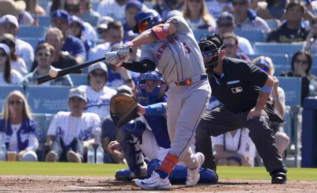 New York Mets' Tyrone Taylor hits an RBI-double against the Los Angeles Dodgers during the second inning in Game 2 of a baseball NL Championship Series, Monday, Oct. 14, 2024, in Los Angeles. (AP Photo/Mark J. Terrill)