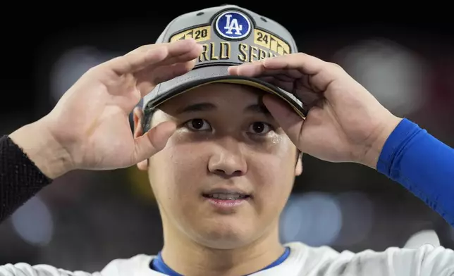 Los Angeles Dodgers' Shohei Ohtani celebrates their win against the New York Mets in Game 6 of a baseball NL Championship Series, Sunday, Oct. 20, 2024, in Los Angeles. The Dodgers will face the New York Yankees in the World Series. (AP Photo/Ashley Landis)