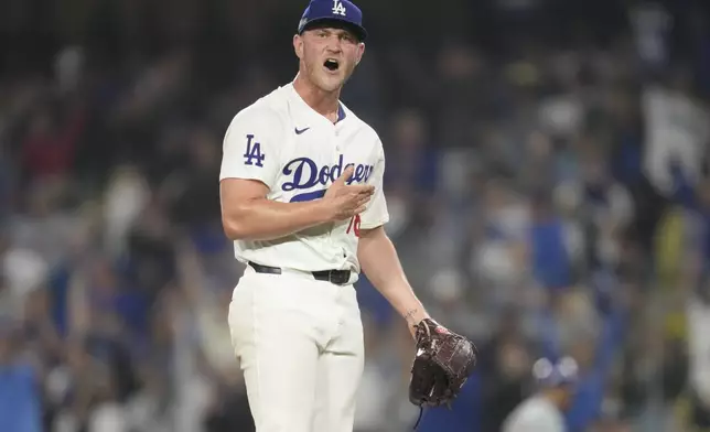 Los Angeles Dodgers relief pitcher Ben Casparius celebrates after their win against the New York Mets in Game 1 of a baseball NL Championship Series, Sunday, Oct. 13, 2024, in Los Angeles. (AP Photo/Ashley Landis)